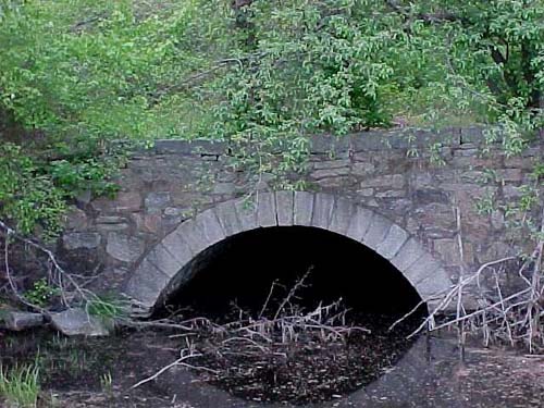 Photo of stone archway over stream