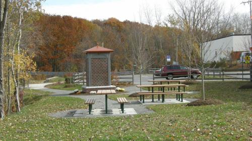 2 picnic tables located right next to parking area