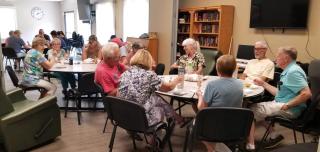 seniors enjoying a meal and conversation