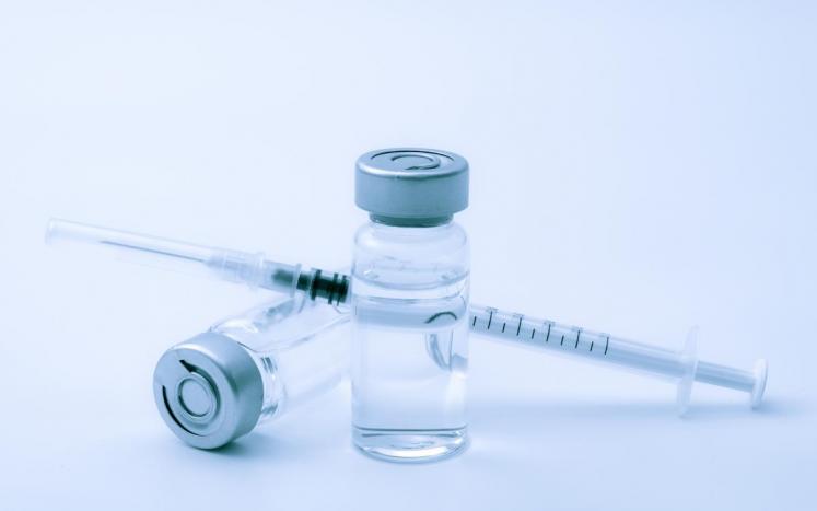 Photo of a syringe and vial.